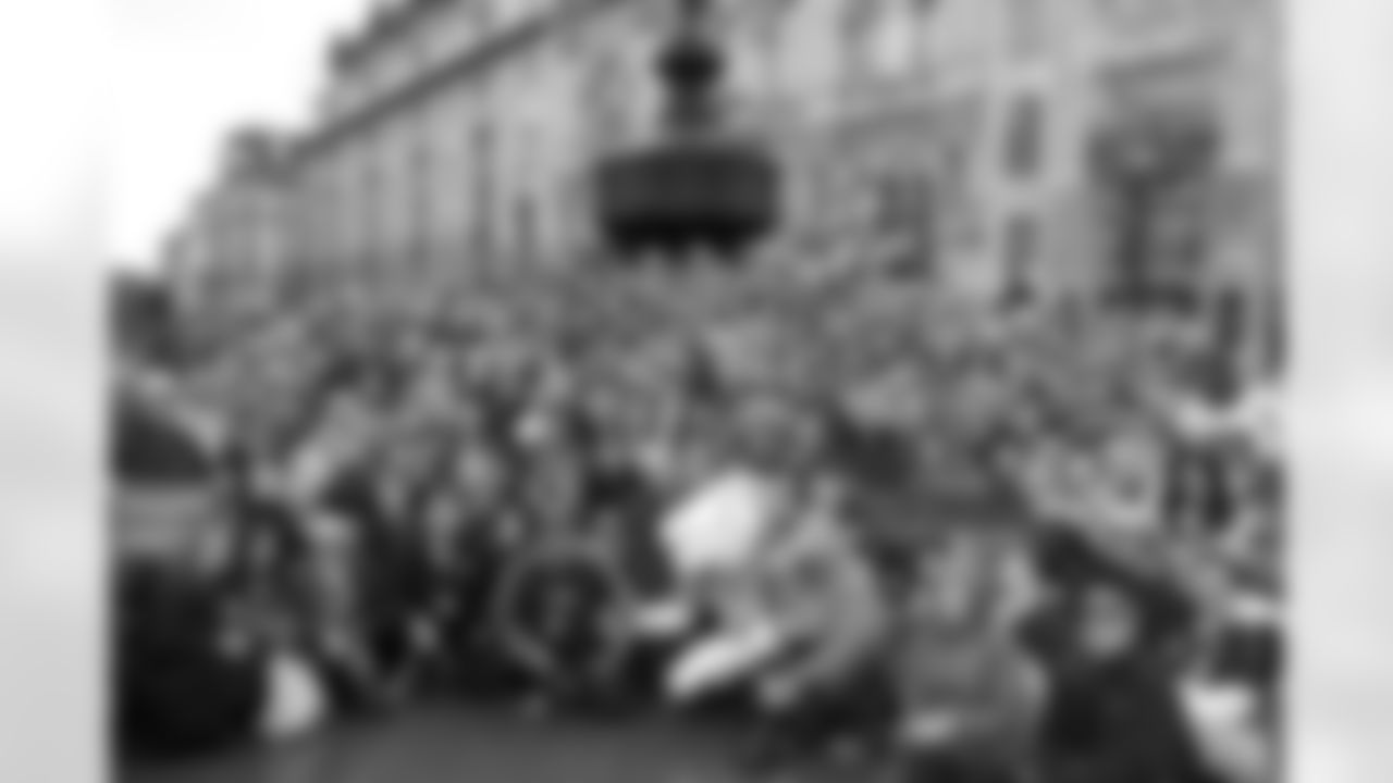 Senior Director of Partnership Marketing Sandy Young and dozens of Broncos fans and staff pose for a photo at London's Piccadilly Circus statue of Eros on October 31, 2010.