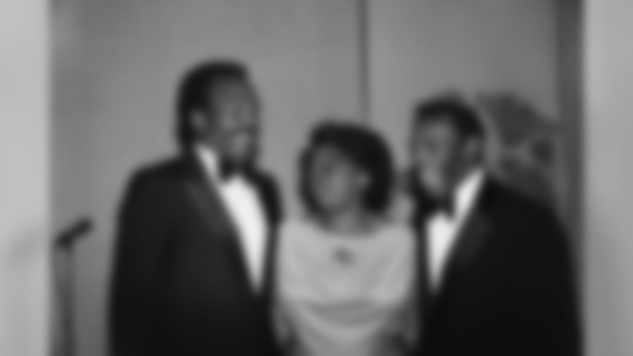 Former National Football League running back star Jim Brown left, chats with Mrs. A. Marie Fleming of Elmira, N.Y. and former Syracuse running back Floyd Little at a dinner, Friday, Oct. 19, 1979, New York. The dinner was held to honor former Syracuse University running back Ernie Davis. Davis, son of Mrs. A. Marie Fleming and the first black to earn the Heisman Trophy, died of leukemia in 1963 but is to be inducted into the National Football Foundation Hall of Fame on Saturday. (AP Photo/Bailey)