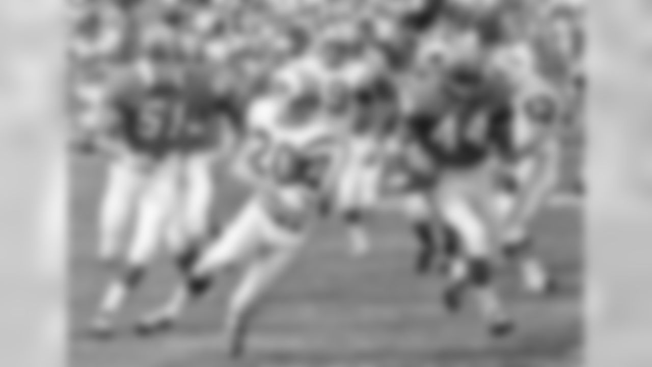 Denver Broncos running back Floyd Little (44) runs past New York Jets punter Steve O'Neal (2) during a football game in Denver on Sept. 21, 1969. (AP Photo/File)