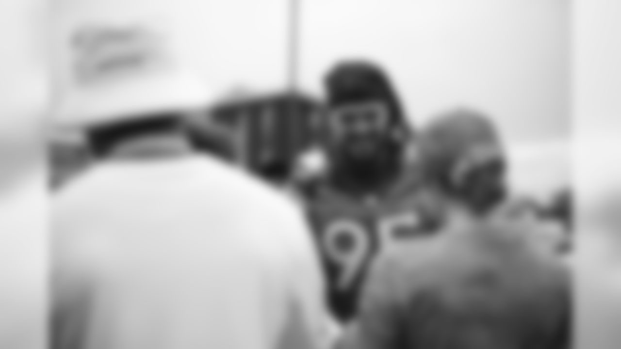 Derek Wolfe signs autographs for military members from the USAA Salute to Service NFL Boot Camp after practice on August 21, 2019 at UCHealth Training Center.