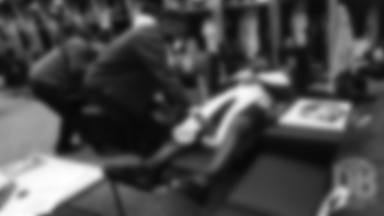 Emmanuel Sanders lays a pair of pants over Bradley Chubb's legs during a visit to the Colorado Rockies' clubhouse at Coors Field on May 29, 2019.
