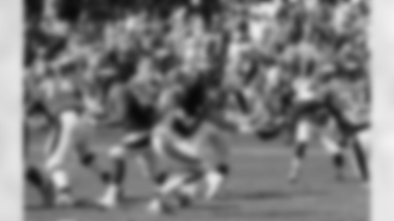 QB Adam Weber hands off to RB Ronnie Hillman.