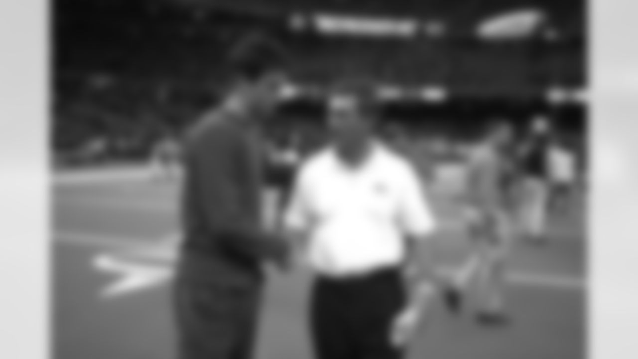 Mike Shanahan is congratulated by his son Kyle after the Broncos victory in New Orleans against the New Orleans Saints at Louisiana Superdome in New Orleans, LA on December 3, 2000.