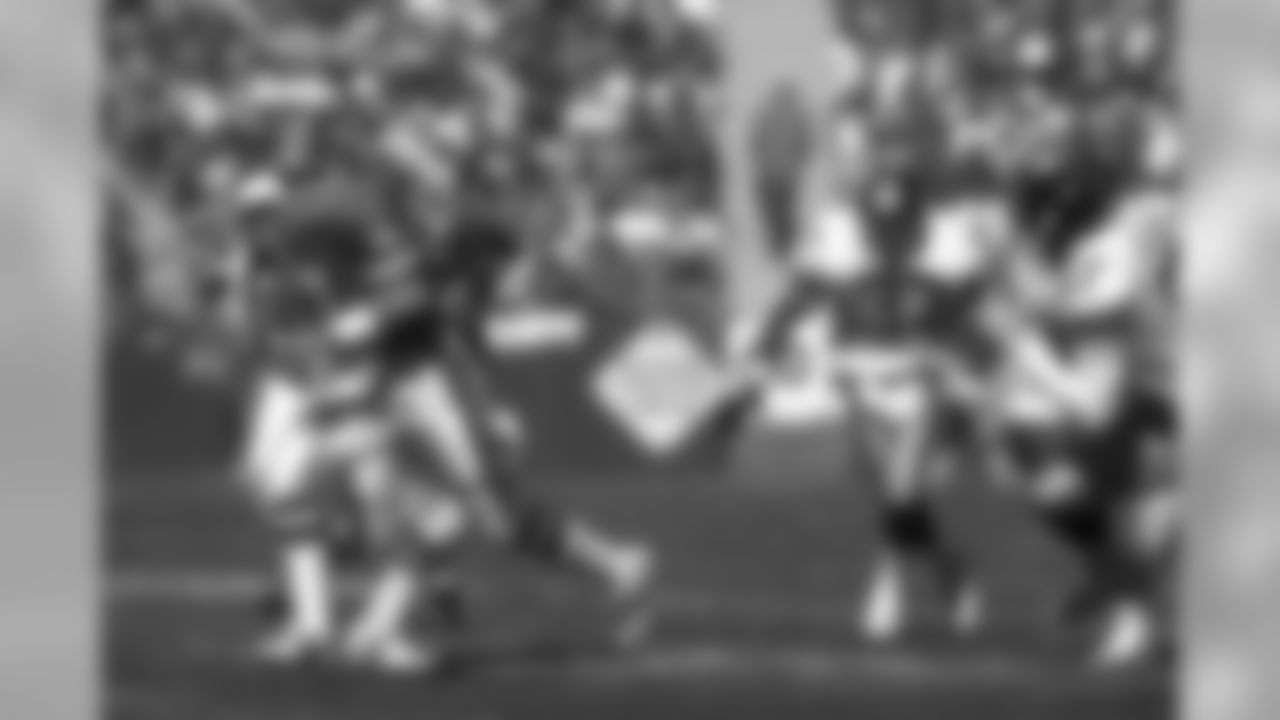 John Elway scrambles out of the pocket against the Pittsburgh Steelers.