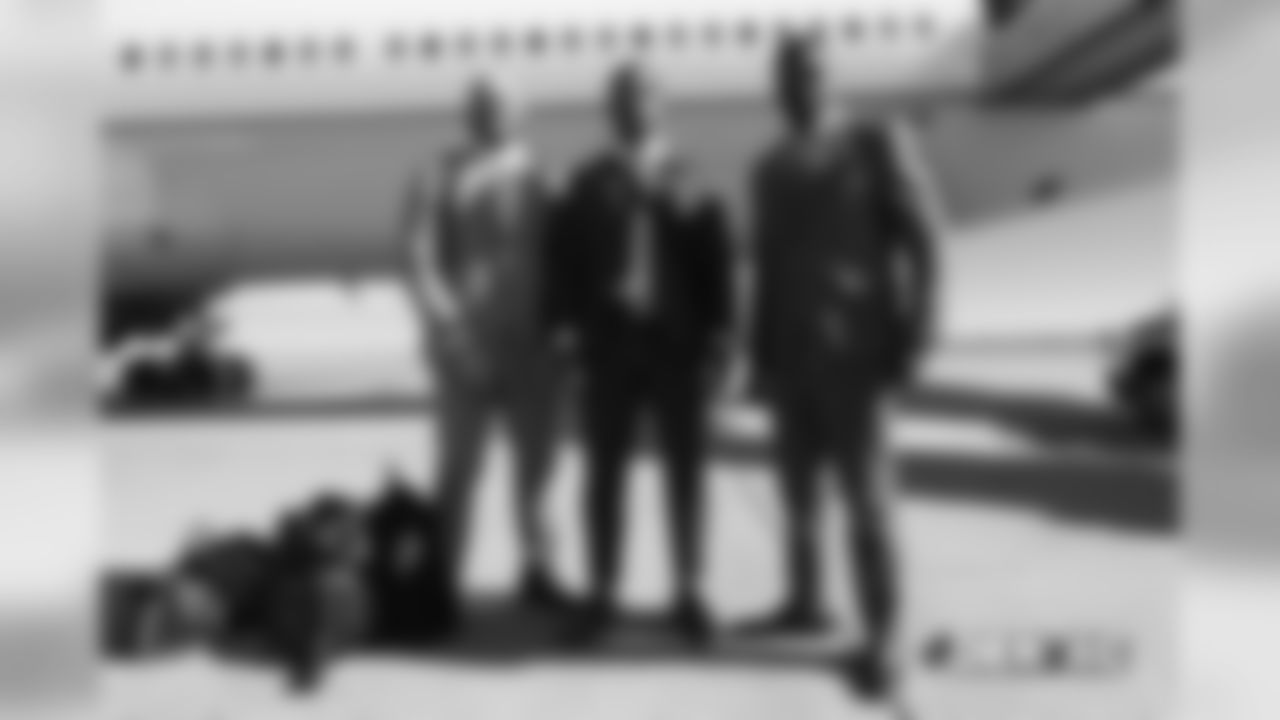 Adam Gotsis, DeMarcus Walker and Jeff HollandÊwalks on the tarmac to the plane before the flight during the team's travel for their Week 8 game against the Kansas City Chiefs on October 27, 2018.