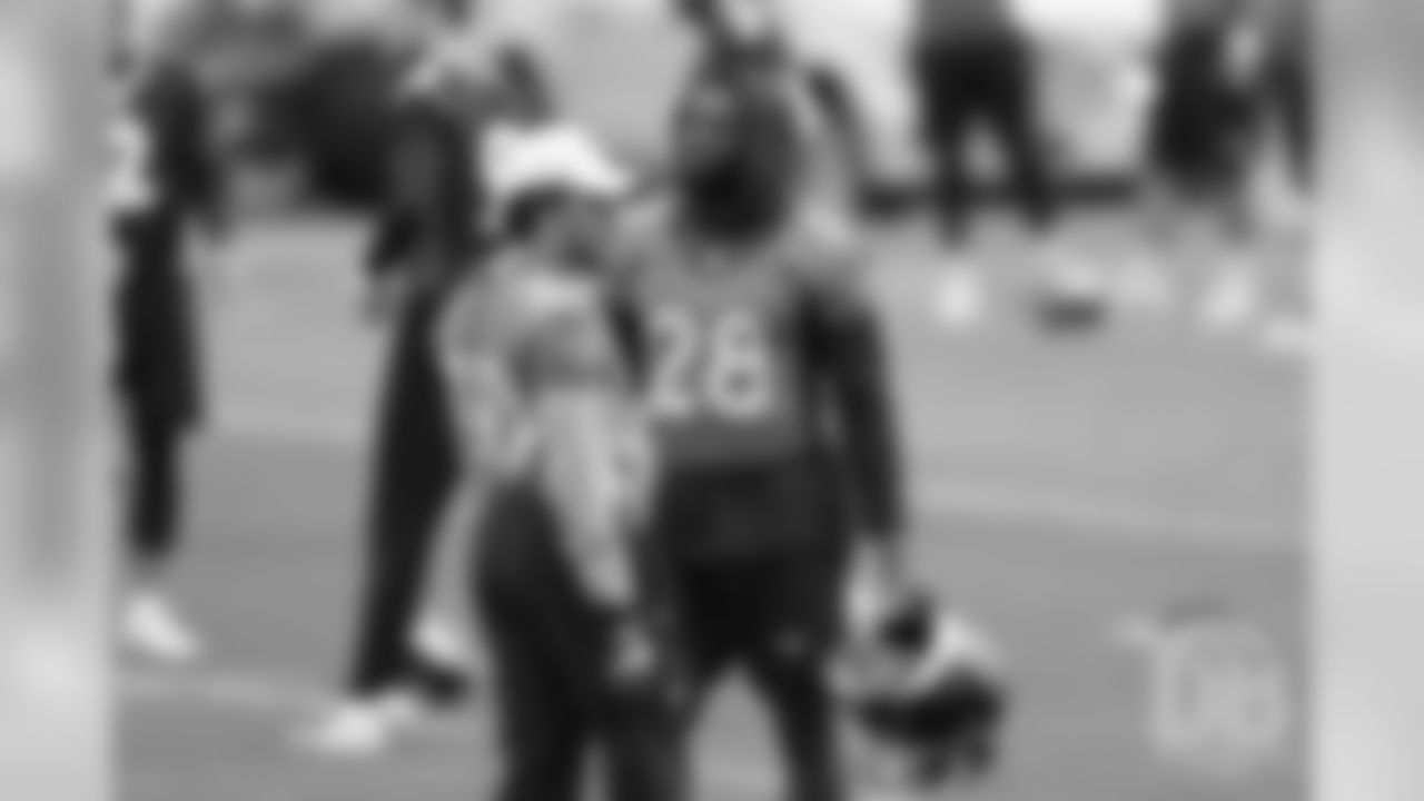 Running backs Phillip Lindsay and Royce Freeman talk before warmups during the first day of voluntary veteran minicamp on April 16, 2019.