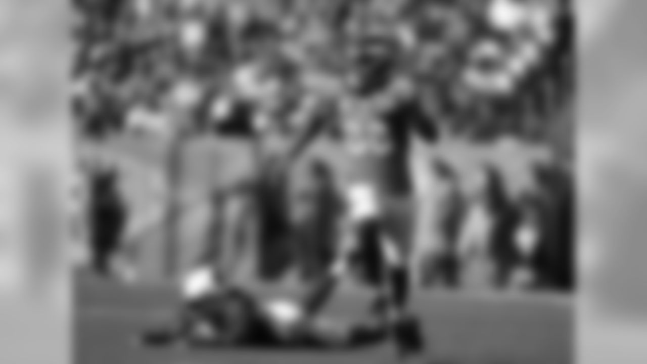A Cardinals defender looks on after missing a tackle on Demaryius Thomas, who would sprint to an 86-yard touchdown, the longest reception he has had in his career.