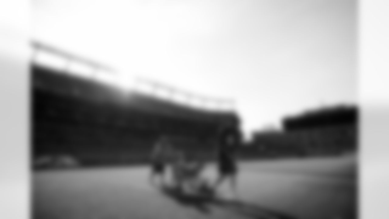 Members of the stadium's turf crew paint the field at Empower Field at Mile High on September 23, 2021 ahead of the team's Week 3 home opener. (Photo by Ben Swanson)