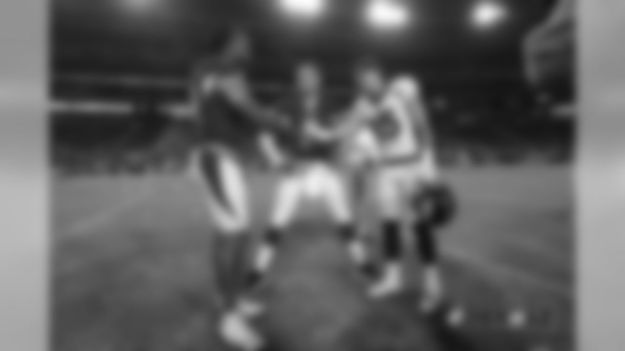 River Cracraft, talking with Cardinals quarterback Josh Rosen, greets receiver Larry Fitzgerald after the Broncos' preseason game against the Arizona Cardinals on August 30, 2018.