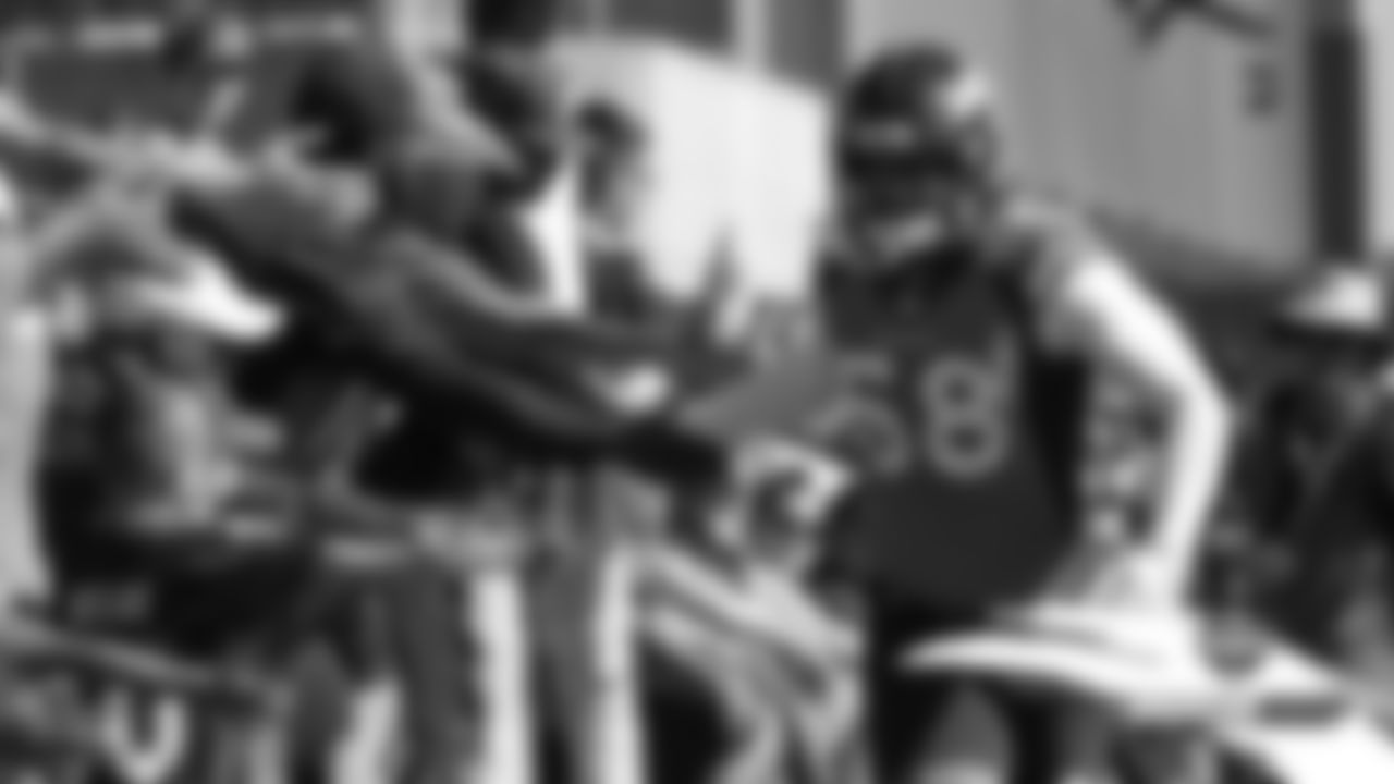 Von Miller high-fives fans during practice on Day 2 of training camp on July 19, 2019.