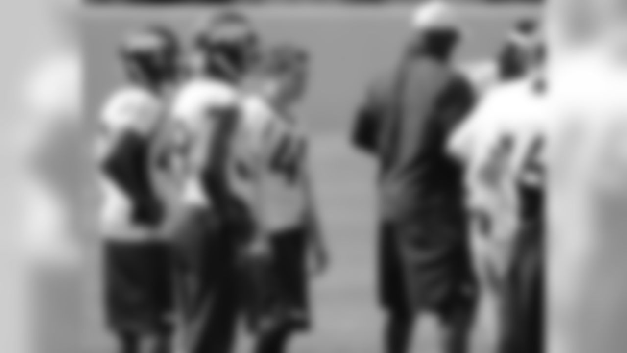 The team's safeties gather around Assistant Secondary Coach Sam Garnes.