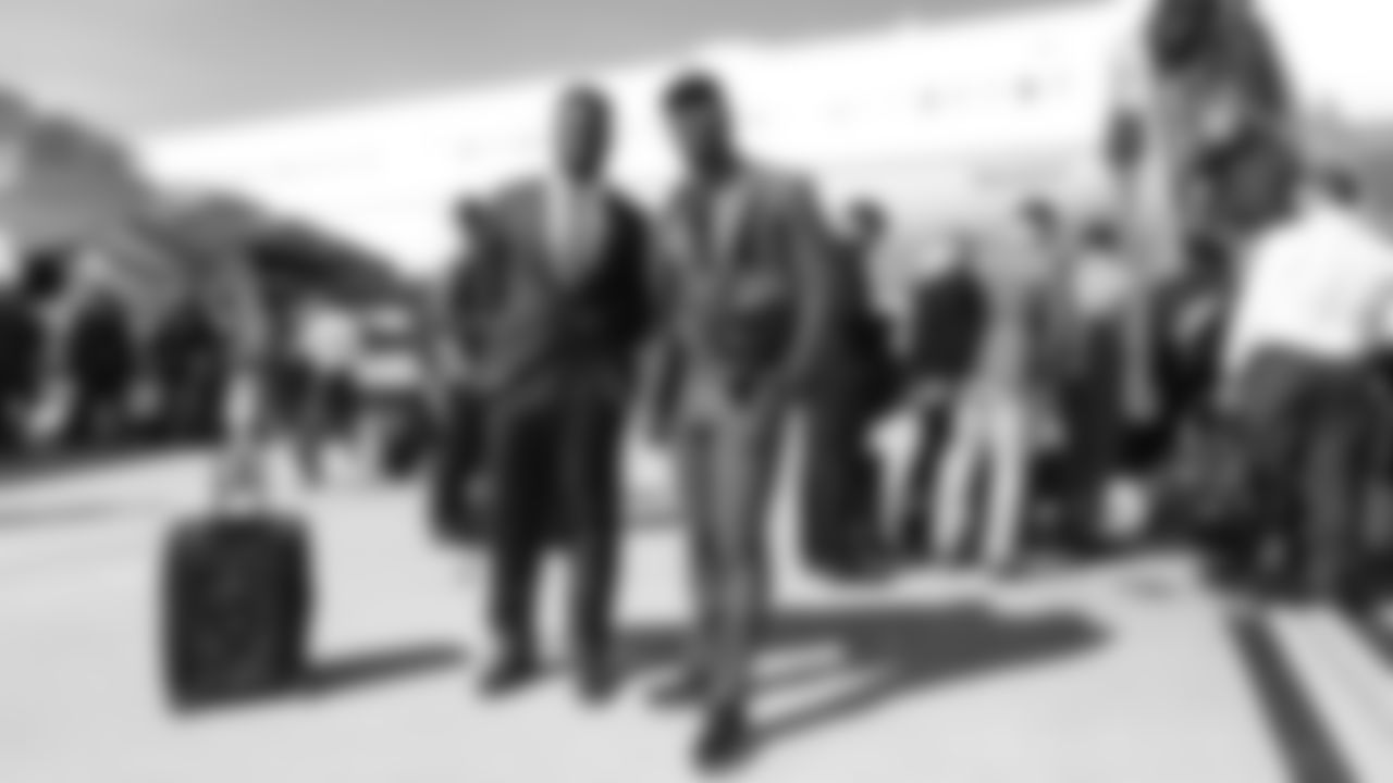 Jeremiah Attaochu and Von Miller on the tarmac at Denver International Airport during the team's travel to California on October 5, 2019 ahead of their Week 5 game against the Los Angeles Chargers. (Photo by Ben Swanson)