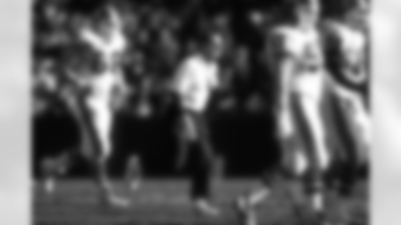 Offensive line coach Alex Gibbs runs on the field during a December 24, 1995 win (31-28) against the Oakland Raiders.