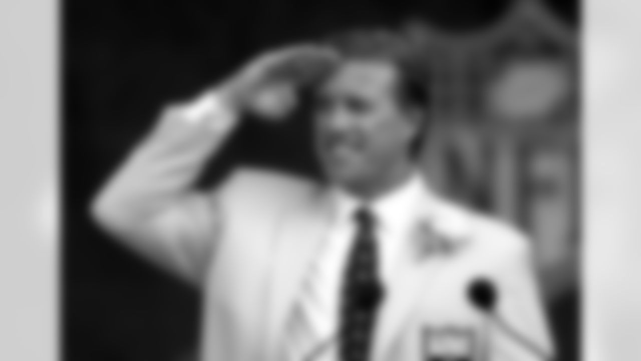 Former Denver Broncos quarterback John Elway gives a final Mile High Salute after speaking at the Pro Football Hall of Fame Sunday, Aug. 8 , 2004, in Canton, Ohio. Elway, Barry Sanders, Bob Brown and Carl Eller were inducted into the Pro Football Hall of Fame on Sunday as the Class of 2004. (AP Photo/Tony Dejak)