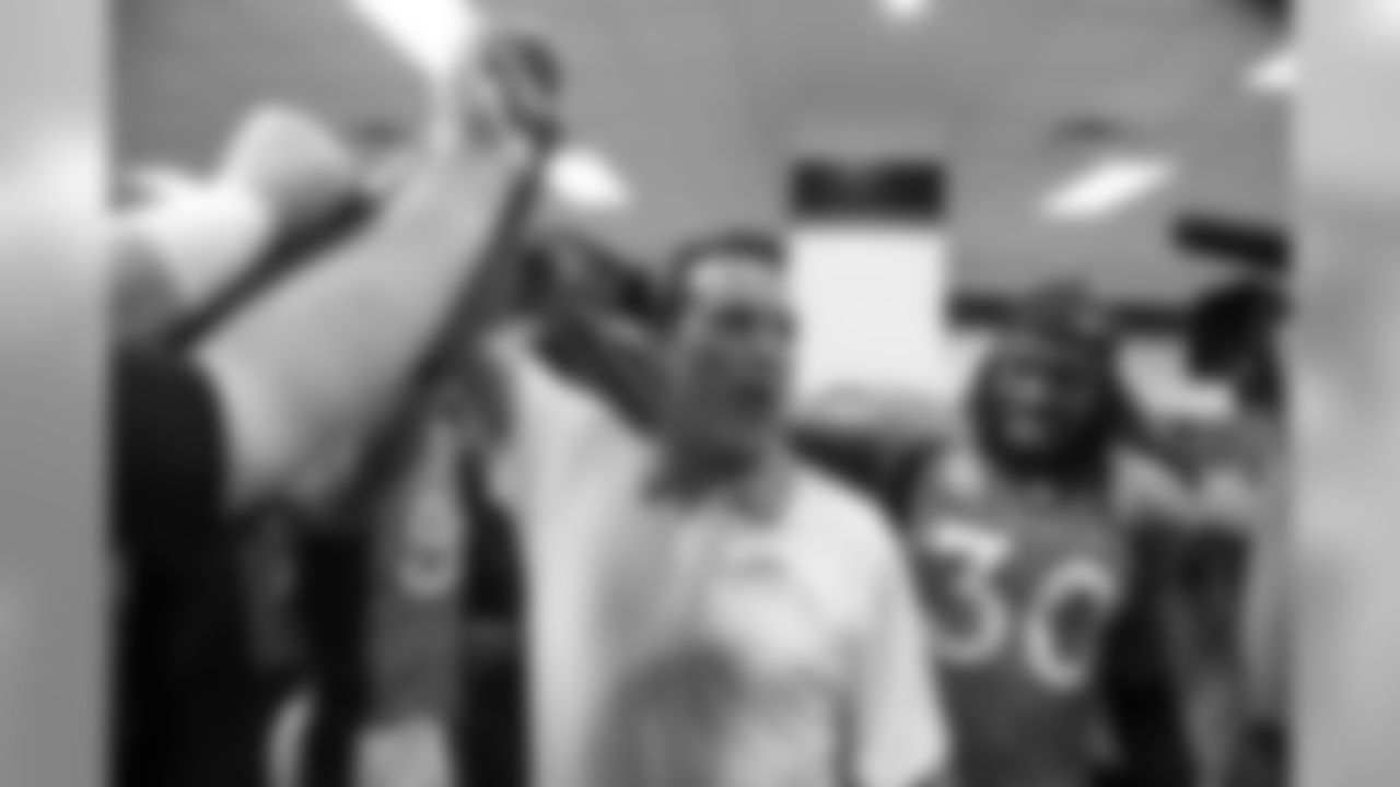 Head Coach Gary Kubiak and S David Bruton Jr. (30) in the locker room after the win over the Ravens.