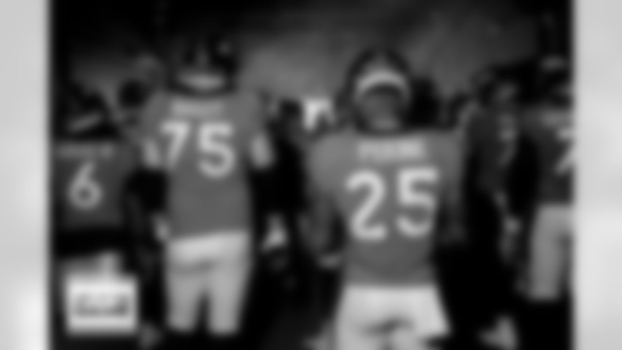 Denver Broncos offensive tackle Quinn Bailey (75), running back Samaje Perine (25) and others in the tunnel before the Broncos' Week 7 game against the Green Bay Packers at Empower Field at Mile High in Denver, Colorado on October 22, 2023. Photo by Ben Swanson / Denver Broncos