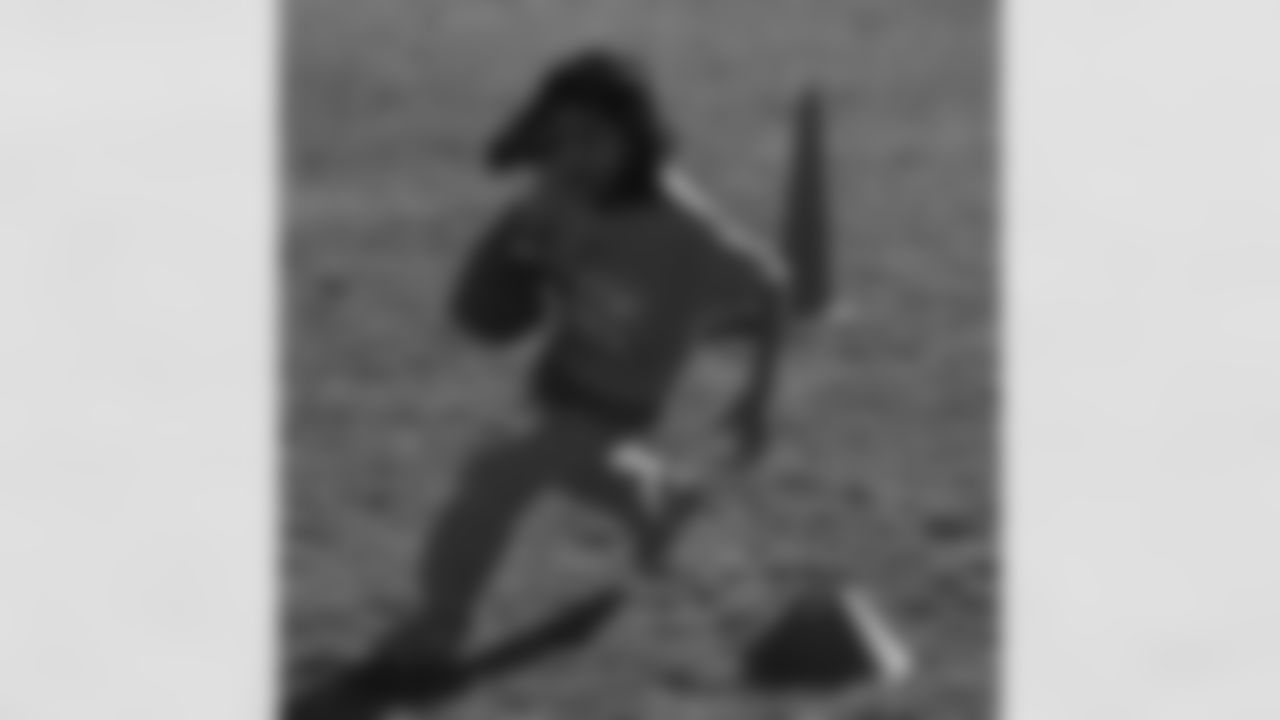 A girl weaves through cones to show her agility.
