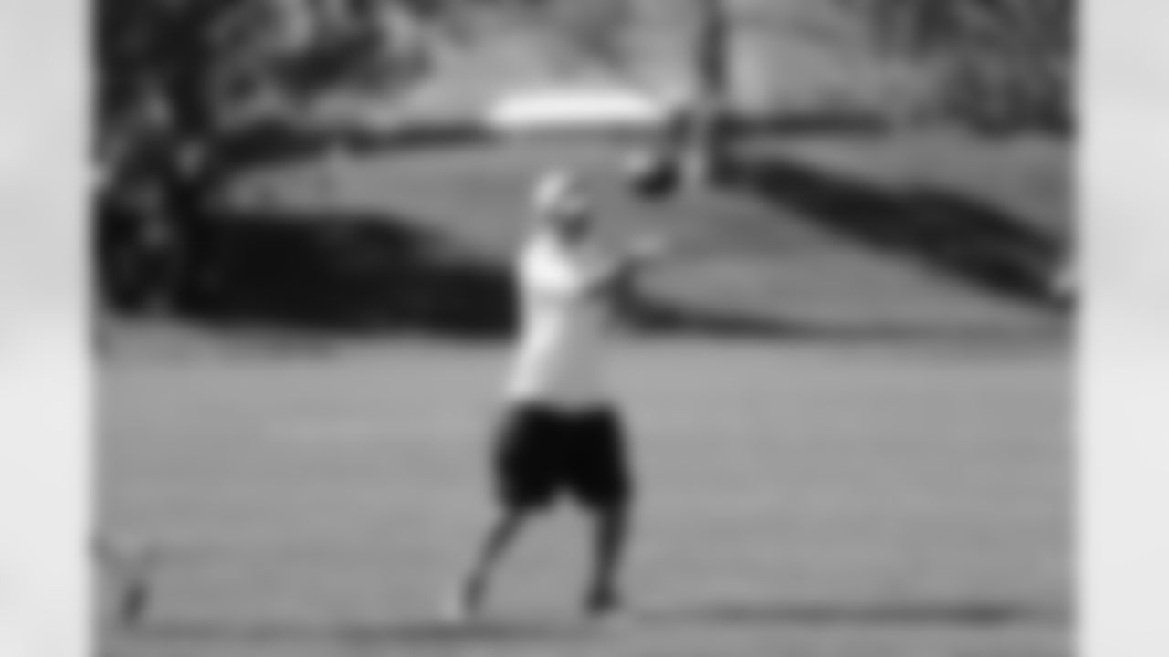 Asst. Turf Manager Cold Dudley throws a pass during a cornerbacks drill.