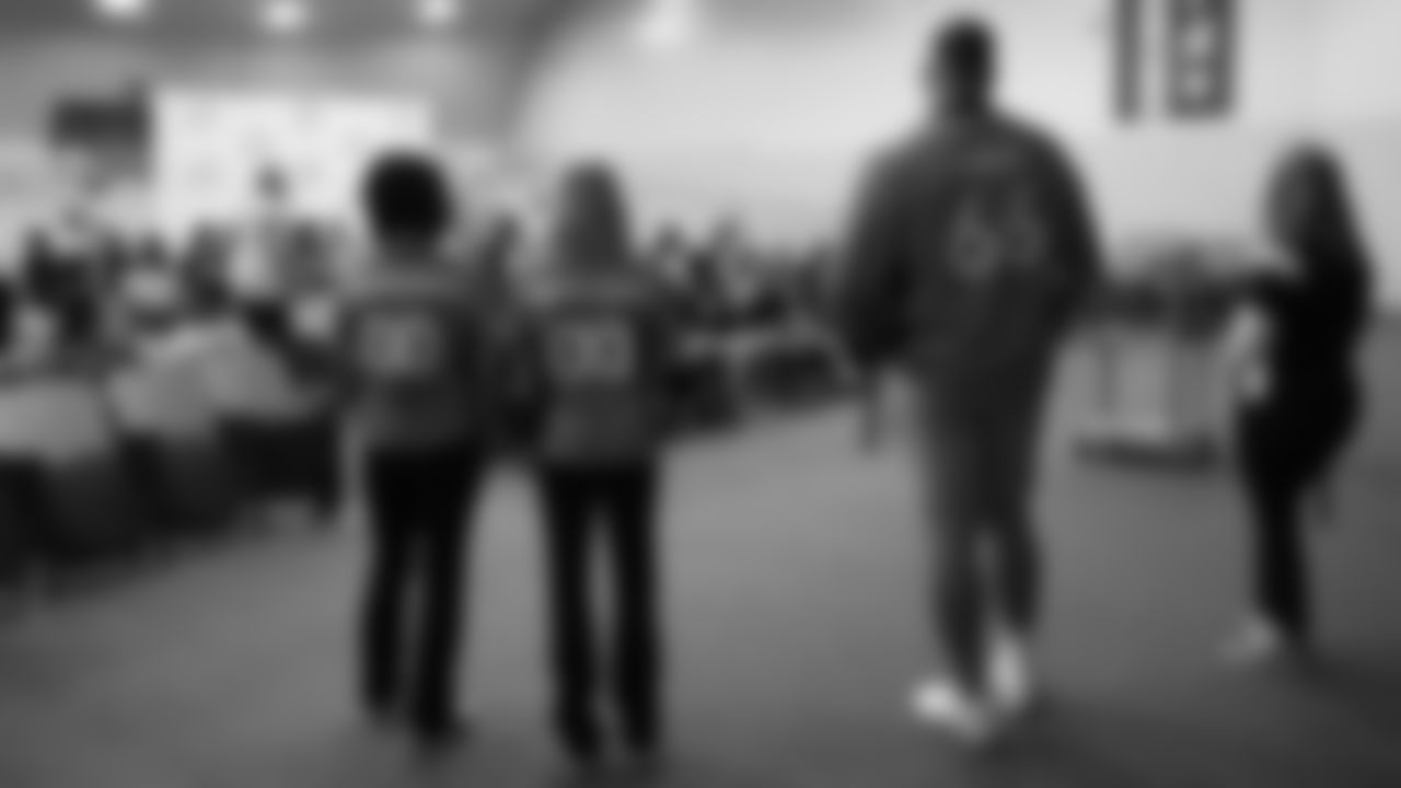 Dalton Risner and two Denver Broncos cheerleaders talk with students at North Middle School in Aurora, Colorado for a Character Playbook School Service event on December 9, 2019. (Photo by Emily Simanskis)