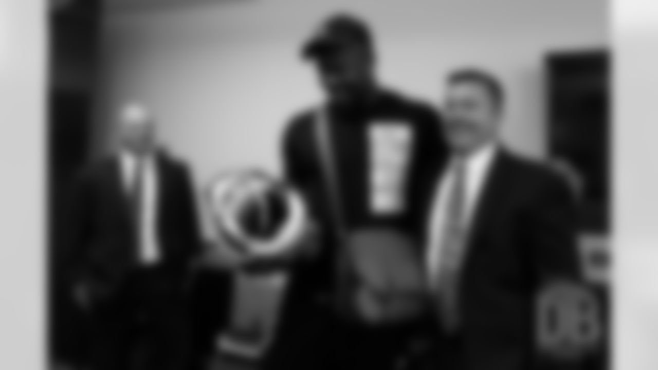 Von Miller receives his Super Bowl 50 helmet from FBI special agent Brian Schmitt.