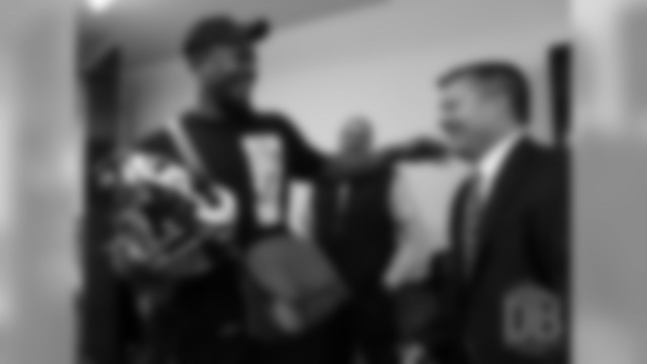 Von Miller receives his Super Bowl 50 helmet from FBI special agent Brian Schmitt.