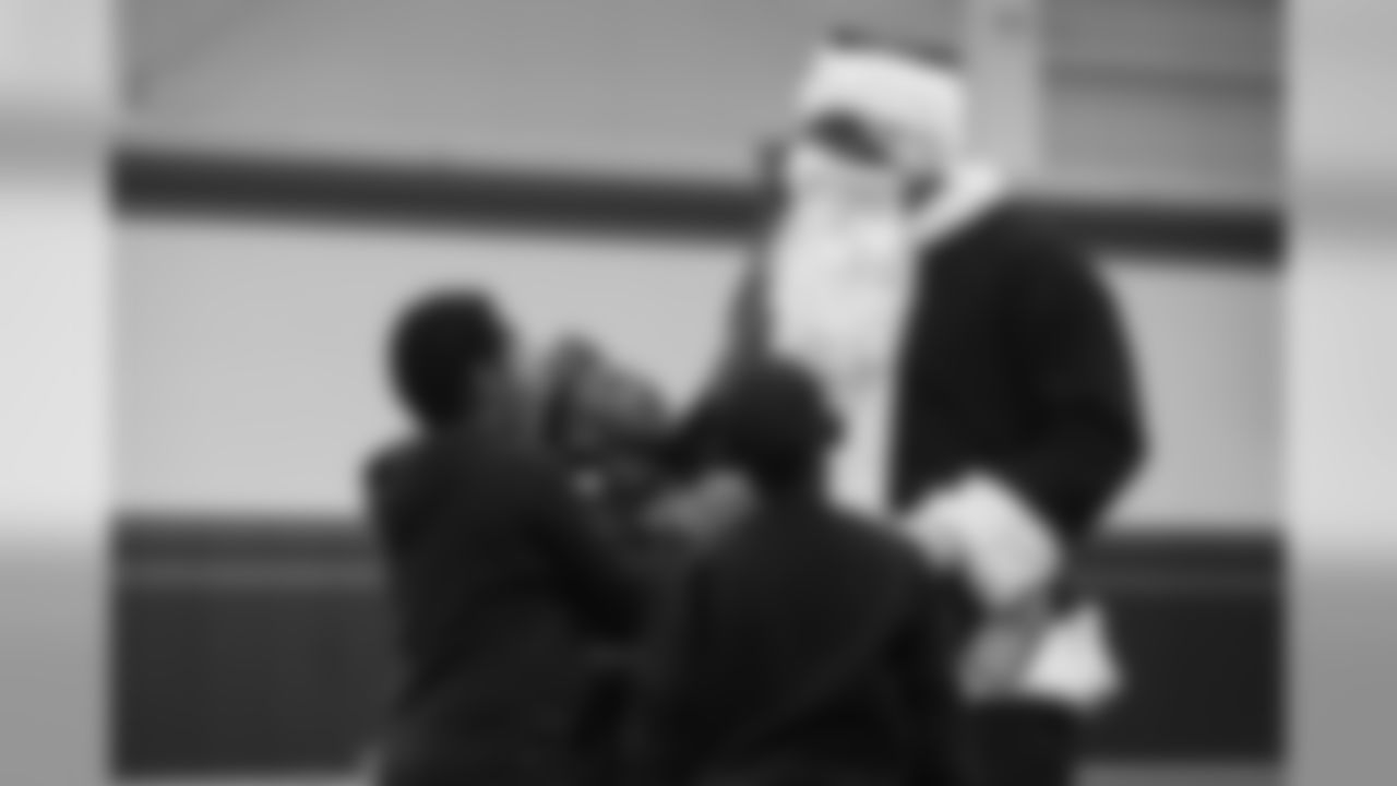 A group of boys try to remove Von Miller's Santa Claus disguise at the Broncos' Boys & Girls Club holiday party for about 200 children from the Boys & Girls Clubs of Metro Denver at UCHealth Training Center on December 17, 2018.