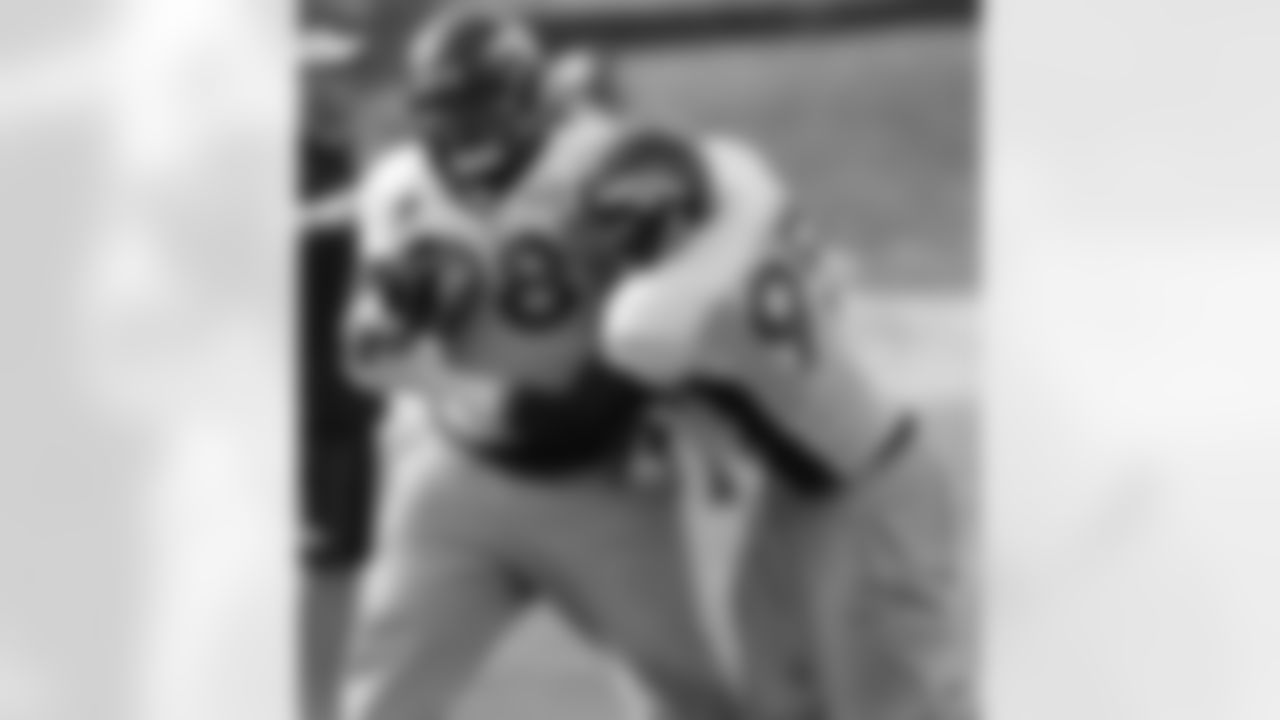 DE Derek Wolfe wraps up DT Sealver Siliga.