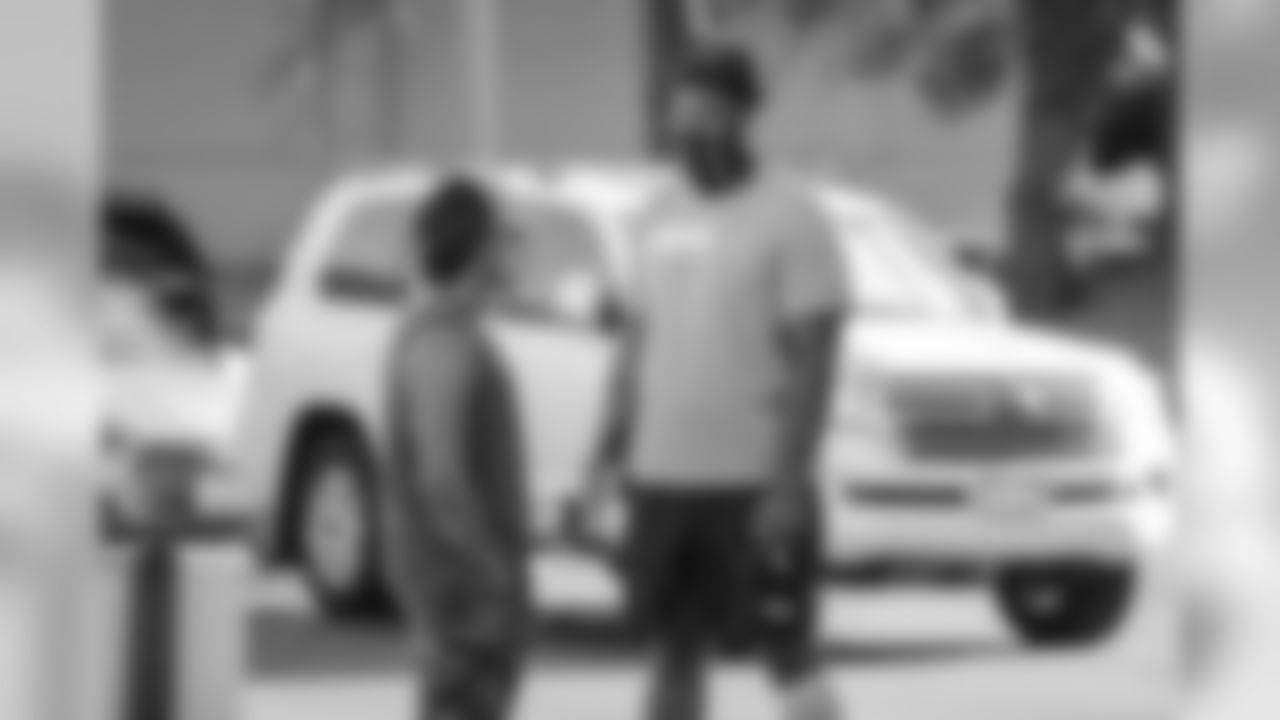 Phillip Lindsay talks with Elijah Wilkinson arrives at UCHealth Training Center for training camp on August 1, 2020. (Photo by Ben Swanson)