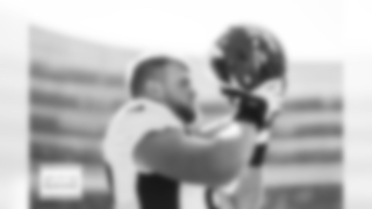 Denver Broncos offensive tackle Mike McGlinchey (69) puts on his helmet before the Broncos' Week 4 game against the Chicago Bears at Soldier Field in Chicago, Illinois on October 1, 2023. Photo by Ben Swanson / Denver Broncos