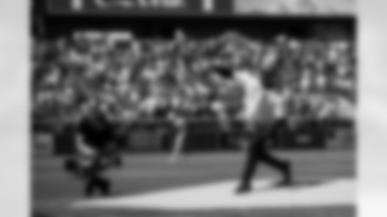 Russell Wilson throws out the first pitch during his visit to the Colorado Rockies' Opening Day game at Coors Field in Denver, Colorado on April 8, 2022. (Photo by Ben Swanson)