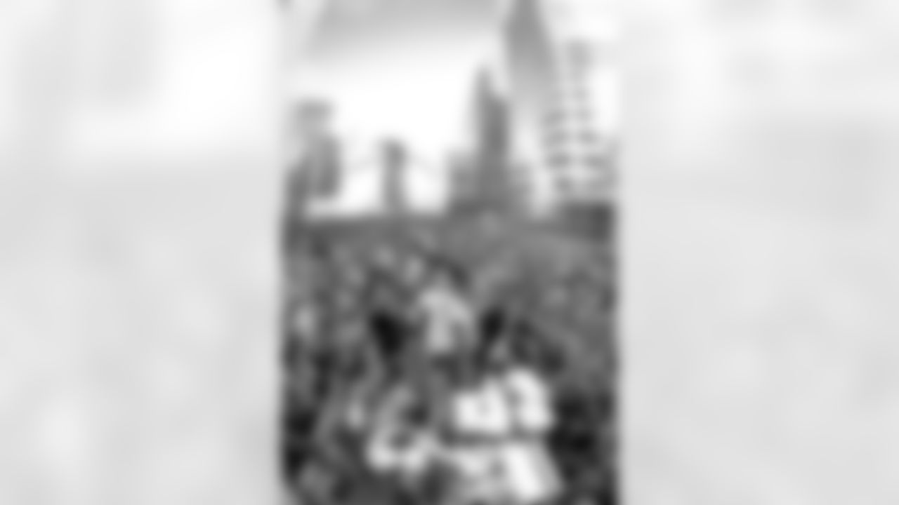 Denver: An estimated 650,000 fans turned out along 17th Street, Broadway and Civic Center Park to cheer on the Broncos during their Championship Parade, the day after returning from the Super Bowl. Here, John Elway and his family wave to the crowd.