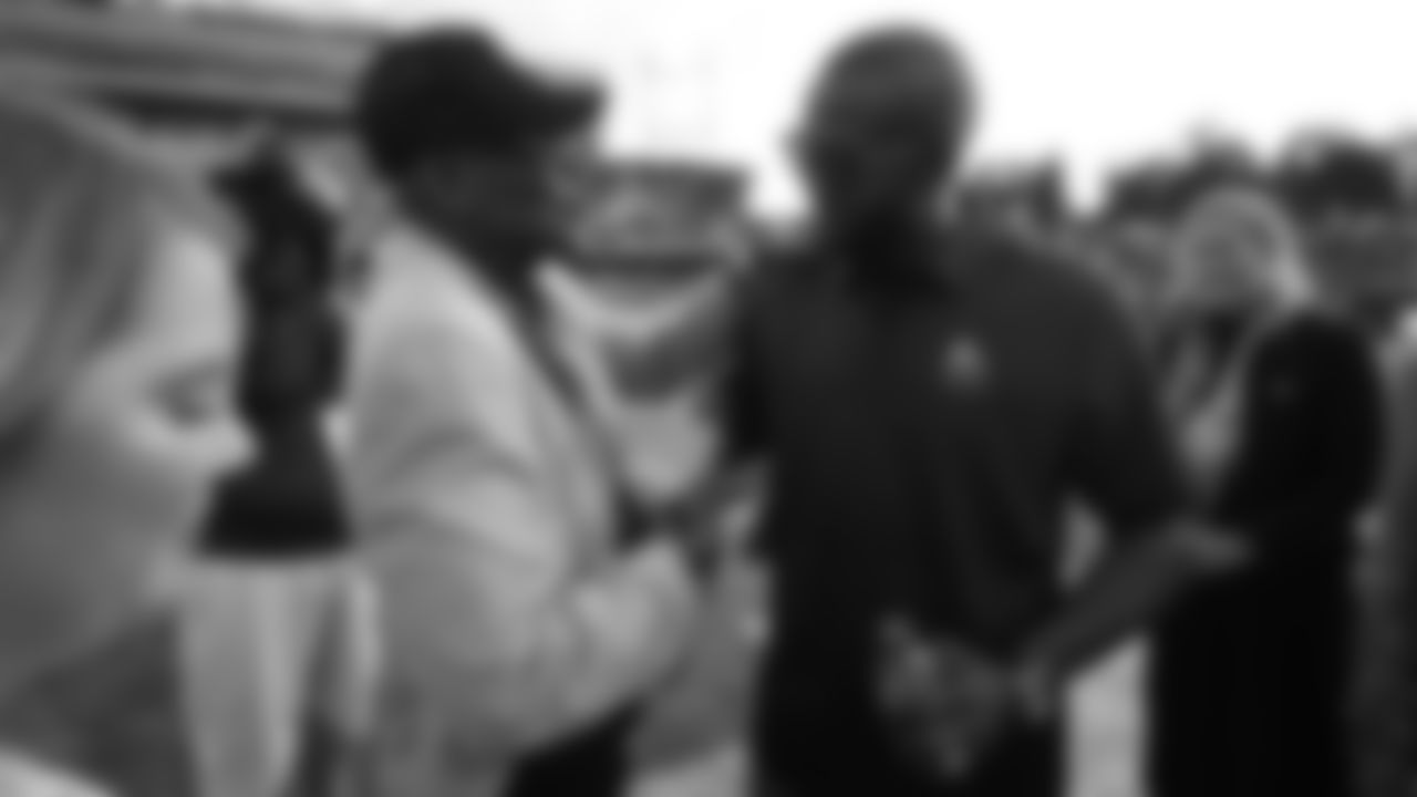 Floyd Little greets Champ Bailey before the Broncos' preseason matchup with the Falcons in the Pro Football Hall of Fame Game on August 1, 2019 at Tom Benson Hall of Fame Stadium.