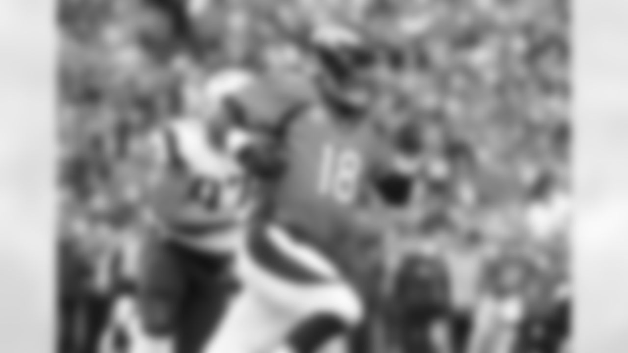 Denver Broncos quarterback Peyton Manning (18) scrambles for a 12 yard gain during third quarter action against the New England Patriots in the AFC Championship on January 24, 2016. It may not have been 'The Helicopter' but this play showed just how much Manning was willing to put on the line to get the Broncos back to the Super Bowl. His two touchdowns gave the Broncos an early lead, and Denver was able to hold on for the win. Photo by Ben Hays.