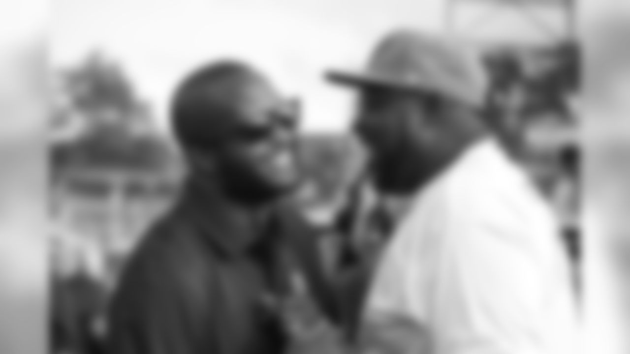 Champ Bailey greets Warren Sapp before the Broncos' preseason matchup with the Falcons in the Pro Football Hall of Fame Game on August 1, 2019 at Tom Benson Hall of Fame Stadium.