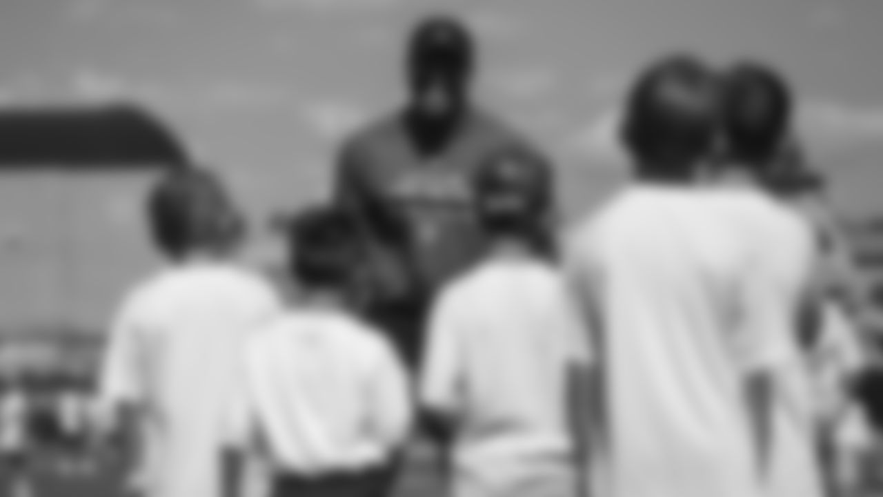 Von Miller interacts with children at his youth football camp at Englewood High School on June 20, 2019.