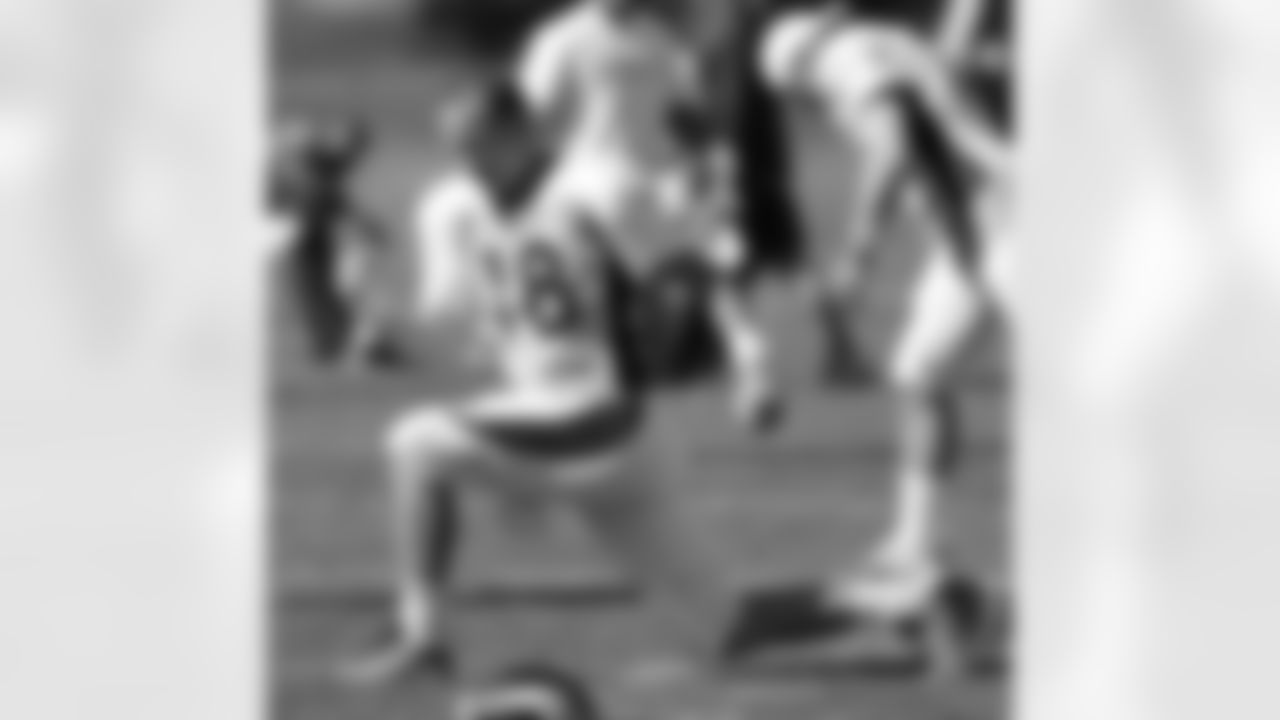 Manning breaks in his pink cleats.