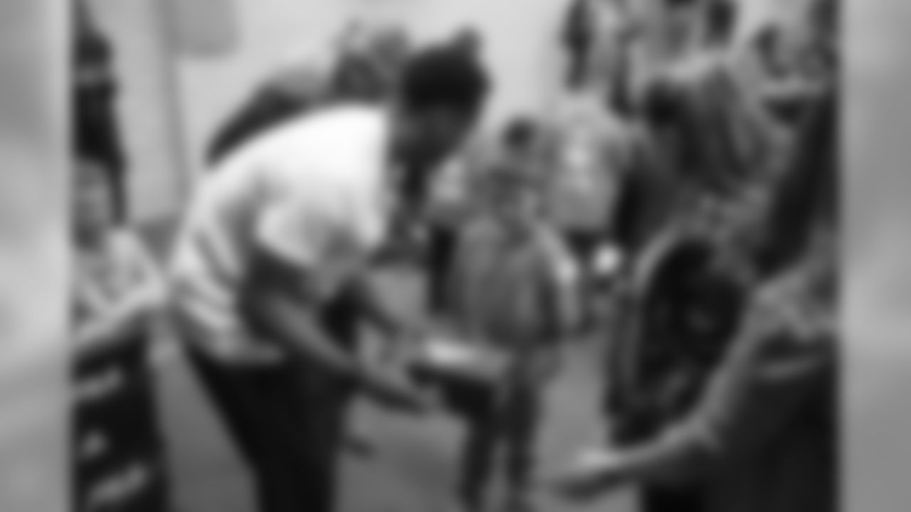 Children at Greenlee Elementary School receive shoes from Courtland Sutton as part of Shoes That Fit, an event with Snooze to help kids get shoes just before the holidays, on December 2, 2019. (Photo by Jeremy Rincon)