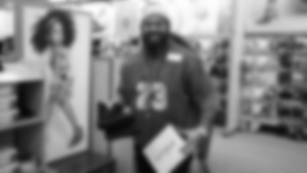 Domata Peko Sr. picks out some boots during Will Parks' shopping spree for the Boys & Girls Club of Metro Denver on Dec. 3, 2018