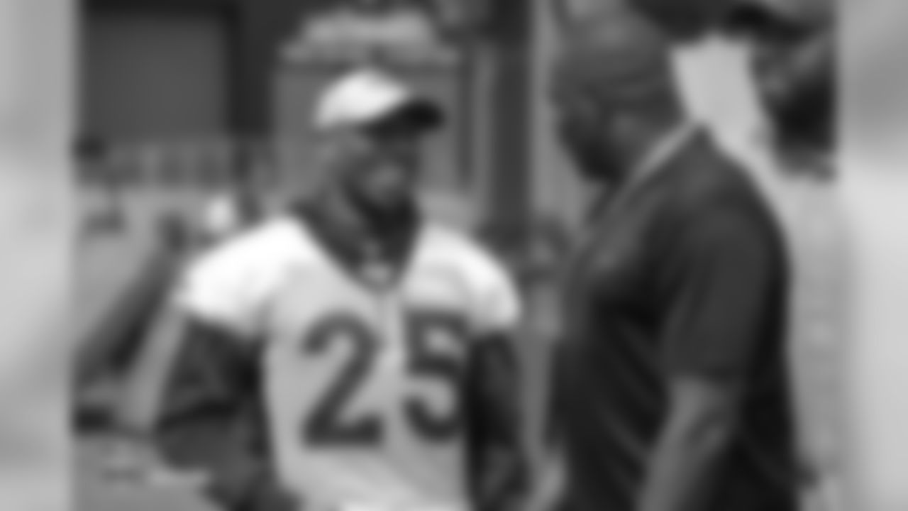 Cornerback Chris Harris Jr. (25) talks with Ring of Fame former wide receiver Rod Smith and former Bronco Kevin Vickerson during the 10th day of training camp on August 8, 2018, at UCHealth Training Center.