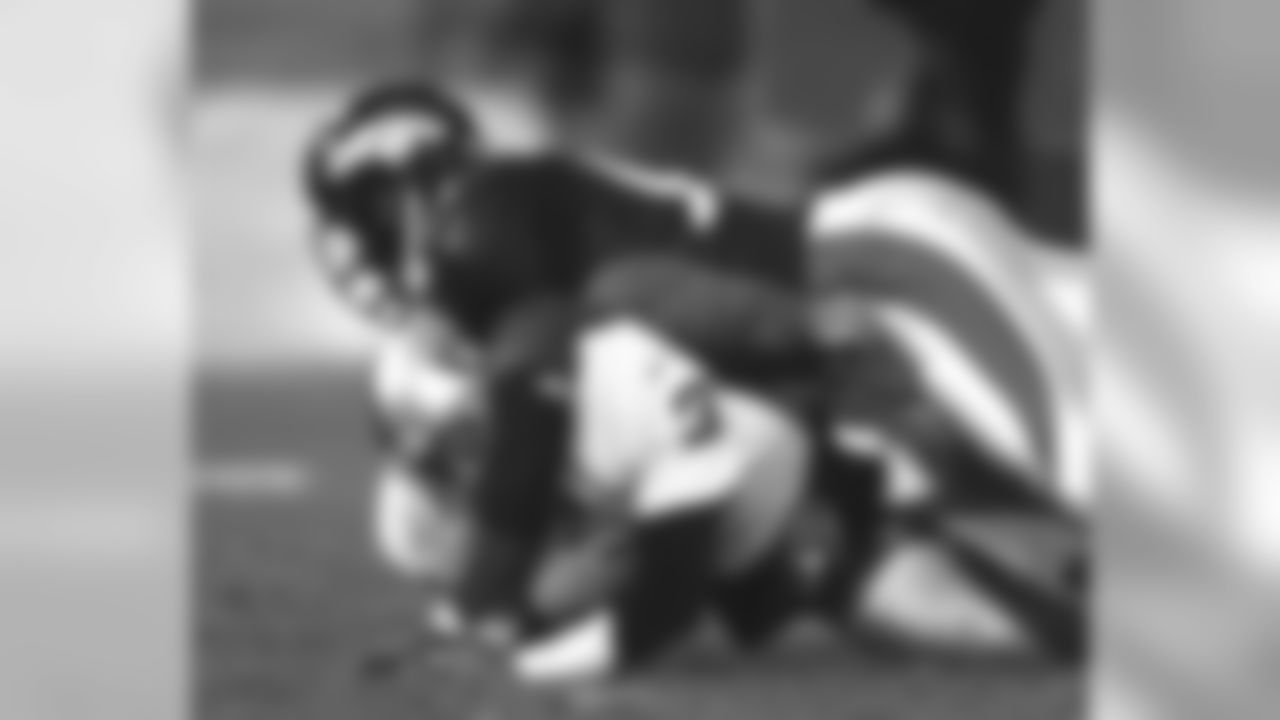 Alfred Williams sacks Jeff George against the Oakland Raiders at Mile High Stadium in Denver, CO on November 24, 1997.