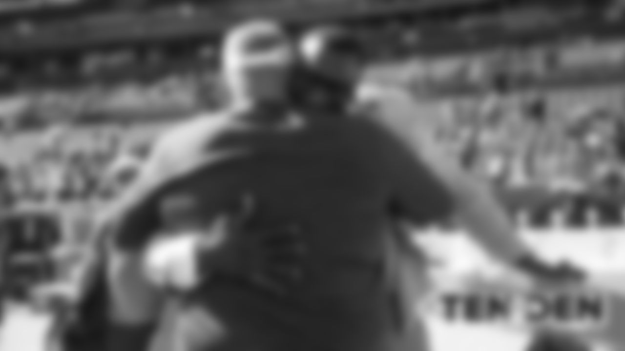 Shannon Sharpe hugs Tight Ends Coach Wade Harman, who coached Sharpe in Baltimore, before the Broncos' game against the Tennessee Titans at Empower Field at Mile High on October 13, 2019. (Photo by Ben Swanson)