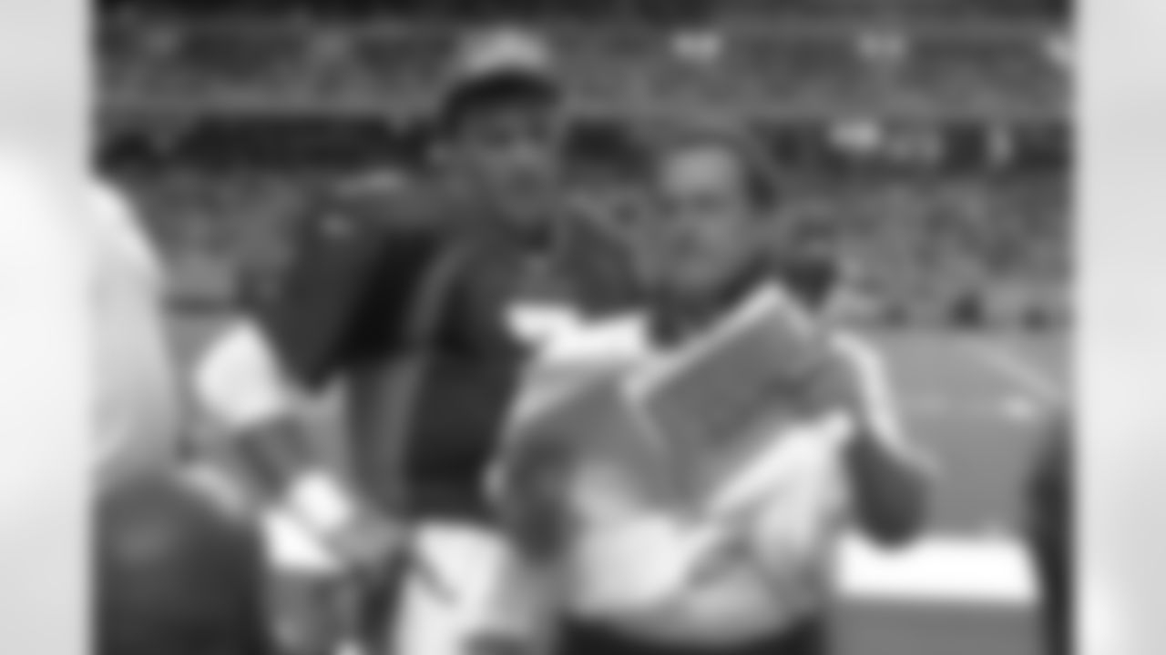 Denver Broncos Alex Gibbs and John Elway review game photos in action against the Atlanta Falcons at GA Dome in Atlanta, GA on September 28, 1997.