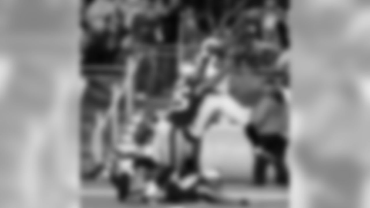 Thomas reaches up over two Patriots defenders to make a catch against New England. With 180 receiving yards, Thomas set his career-best mark to that point.