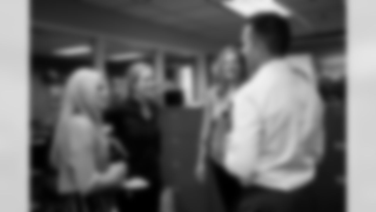 General Manager George Paton speaks with Brittany Bowlen, Annabel Bowlen, Liz Coates and Broncos staff members during a visit to Empower Field at Mile High in Denver, Colorado on September 29, 2021. (Photo by Ben Swanson)