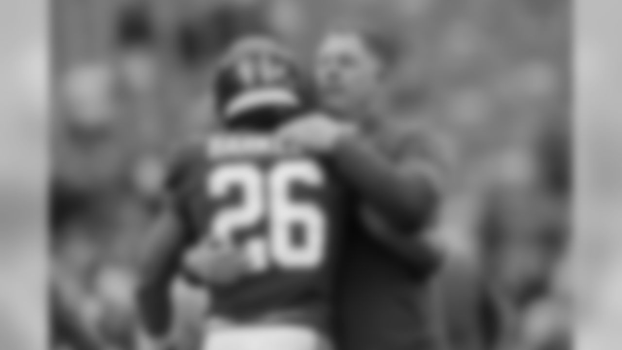 New York Giants head coach Pat Shurmur, right, greets Saquon Barkley before an NFL football game against the Green Bay Packers, Sunday, Dec. 1, 2019, in East Rutherford, N.J. (AP Photo/Adam Hunger)