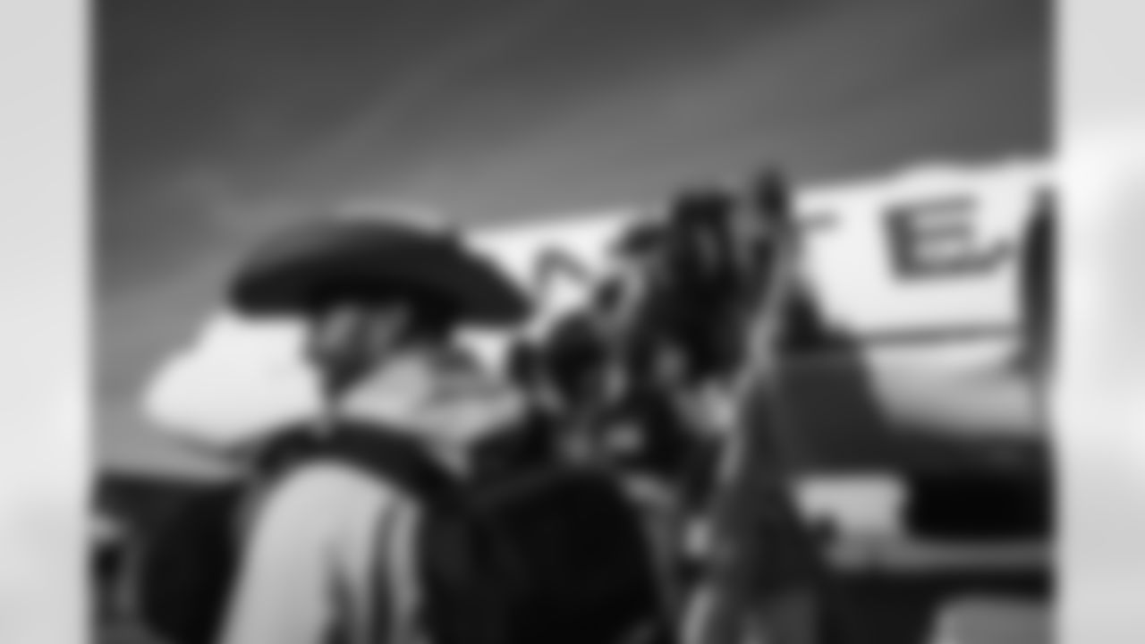 Justin Strnad on the tarmac at Denver International Airport on November 12, 2022 during the team's travel to Tennessee for a Week 6 game against the Titans. (Photo by Ben Swanson)