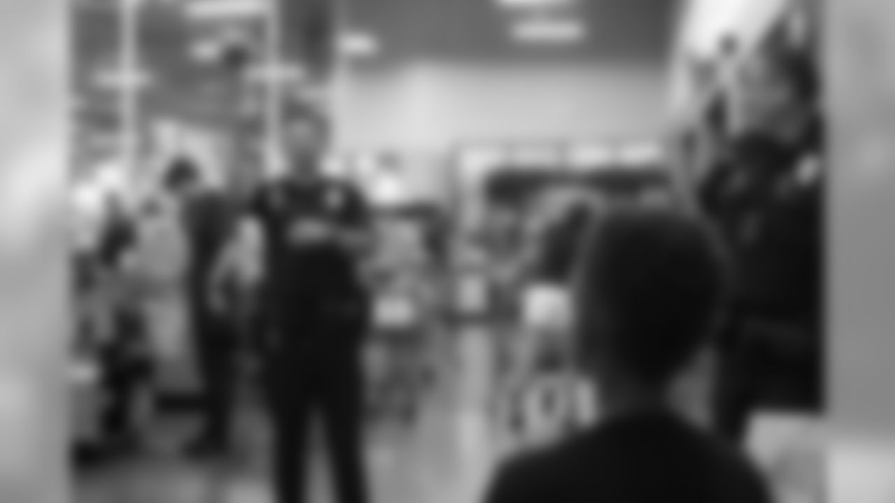 A police officer plays catch with a young boy at the 2018 Back to School with the Broncos shopping spree on July 23, 2018. Each student received $100 for school supplies.