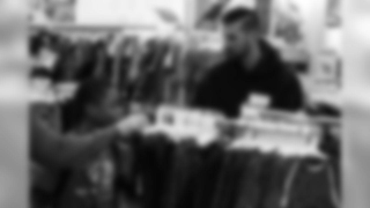 Brandon McManus helps a participant choose clothes during Will Parks' shopping spree for the Boys & Girls Club of Metro Denver on Dec. 3, 2018