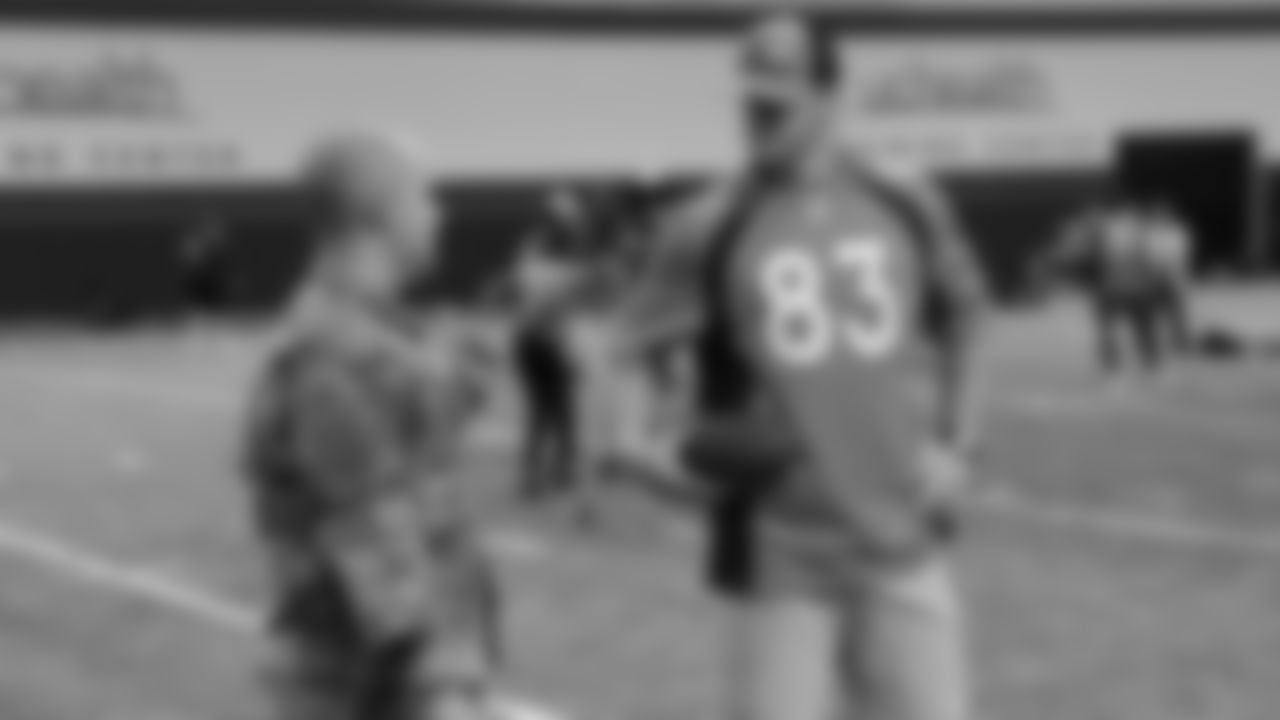 Andrew Beck talks with a veteran during a Salute to Service-themed PLAY 60 clinic for children from military families in the Pat Bowlen Fieldhouse at UCHealth Training Center on November 12, 2019. (Photo by Emily Simanskis)