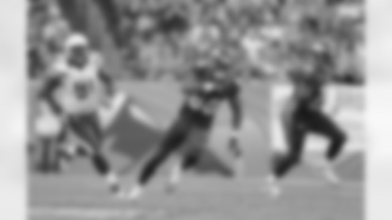Thomas looks for yards after the catch during the first half.